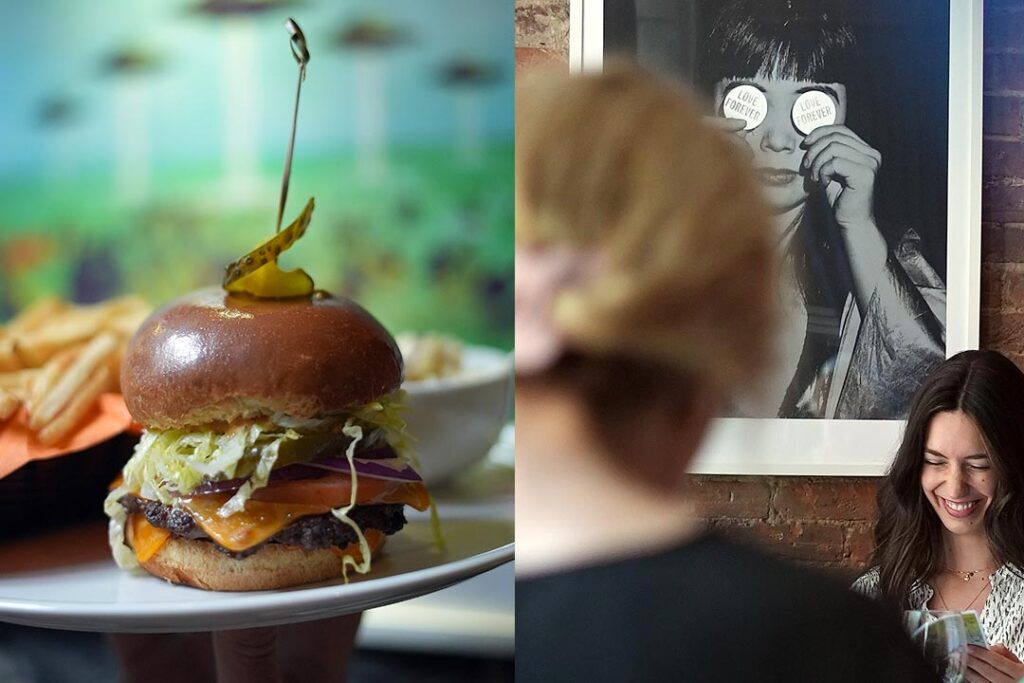 Juicy smash burger with ufo art in the background and a happy customer at Resto le Polisson in Old Montreal